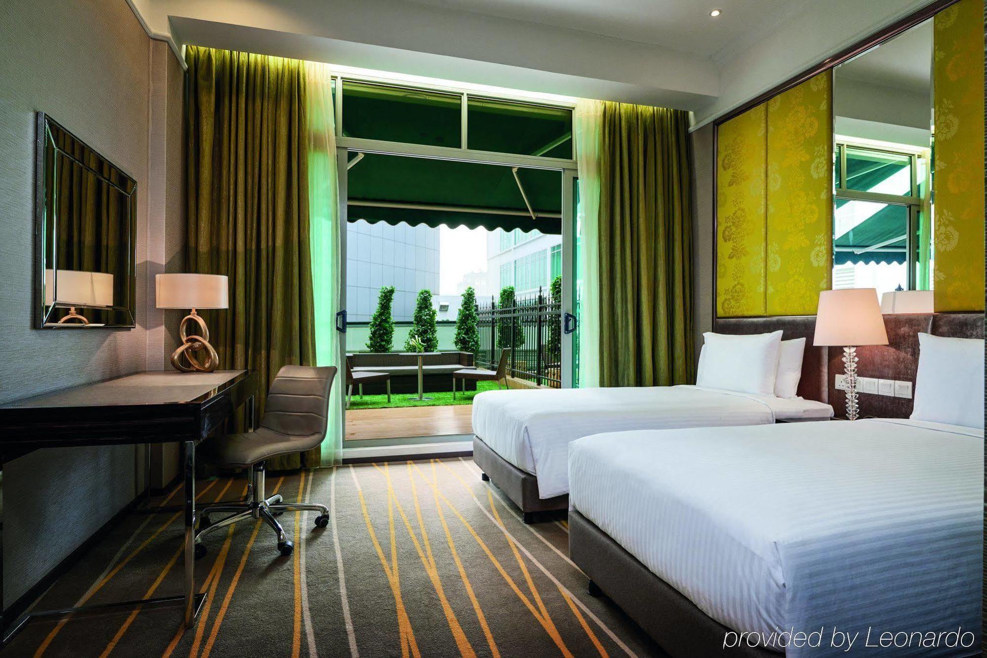 Dorsett Putrajaya Hotel Exterior photo The photo shows a modern hotel room featuring two twin beds, each with white bedding. The room has a stylish decor with a large window that allows natural light to enter. Green curtains frame the window, which opens to a balcony that overlooks an out